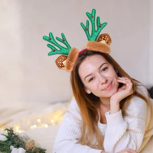Christmas reindeer antler headband with green sequins and brown plush ears for party decor