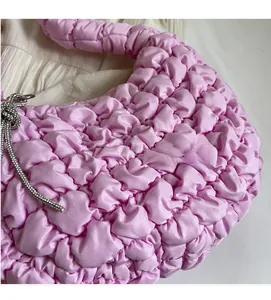Detailed close-up of lavender pleated cloud bag with soft bubble texture and crystal charm