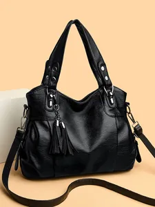 Large black textured leather tote bag with elegant tassel and adjustable shoulder strap