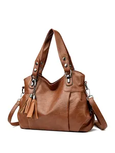 Brown large capacity leather tote bag with silver studs and tassel charm detail
