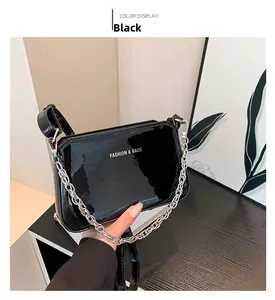 Detail of black glossy leather bag with silver chain and Fashion & Bags text logo