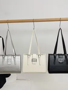 French style tote bags in silver, cream, and black with textured finish and metal buckles