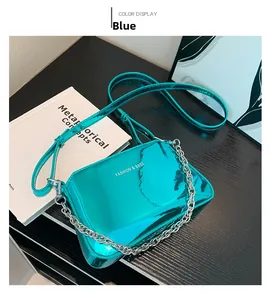 Top view of shiny blue patent leather bag with silver chain strap and fashion text