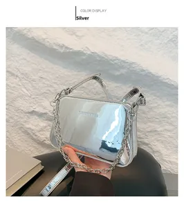 Detail of silver mirror finish shoulder bag with chunky metal chain and text print