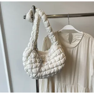 Detailed shot of white pleated cloud bag with sparkling silver rhinestone tassels