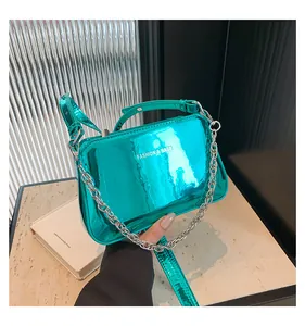 Close-up of mint green metallic handbag with silver chain and FASHION & BAGS logo