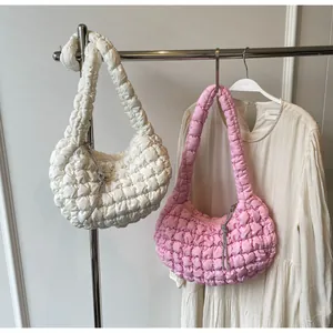 Detail of pink and white quilted puff bag with sparkling silver rhinestone tassels