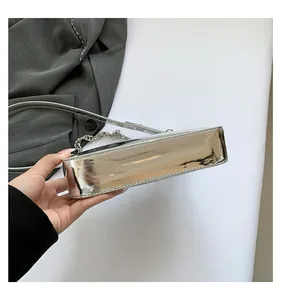 Detailed view of silver mirror leather shoulder bag with metallic chain and sleek finish