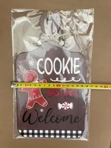 Wooden gingerbread man welcome sign with tape measure showing 16cm width detail
