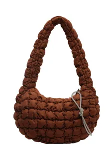 Brown puffer cloud bag featuring quilted bubble texture and a rhinestone bow charm