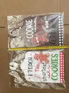 Detail of wooden gingerbread man welcome signs with measuring tape showing 26cm size