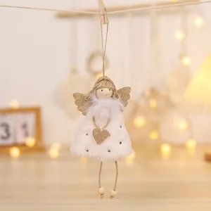 Close-up of plush angel doll ornament with gold star patterns and a glittering gold heart