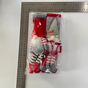 Detail of red and grey Christmas gnome fridge handle covers in clear packaging with scale