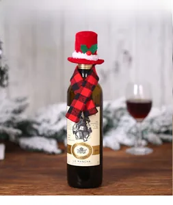 Detail of festive red and black plaid wine bottle cover with mini hat and scarf set