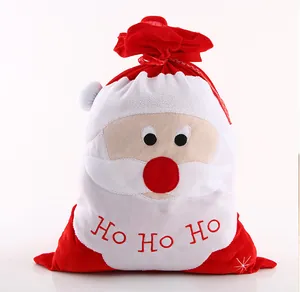 Detailed view of red Christmas drawstring gift bag with Santa Claus and Ho Ho Ho text