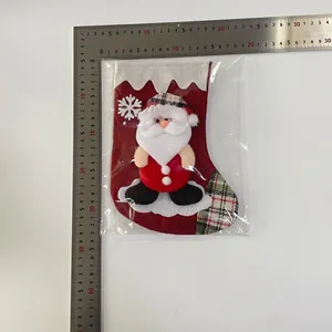 Detailed view of burlap Christmas stocking featuring a 3D Santa doll and measurement scale