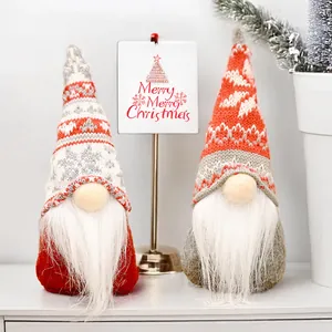 Set of two Christmas gnomes with snowflake knit hats and white beards on festive background