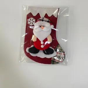 Close-up of linen Christmas stocking with 3D Santa plush and snowflake embroidery