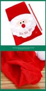 Detail of red Christmas chair cover with Santa face embroidery and HO HO HO text