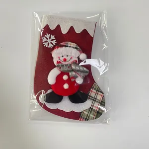 Close-up of a Christmas burlap stocking with 3D snowman doll and white snowflake print