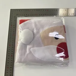 Detailed view of Santa Claus fabric gift bag in flat lay with ruler for size reference