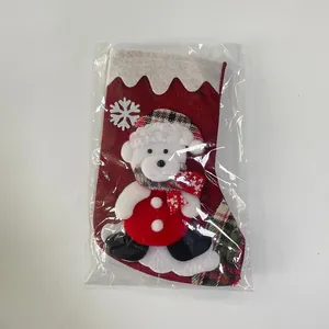 Close-up of red burlap Christmas stocking featuring 3D plush bear and snowflake detail