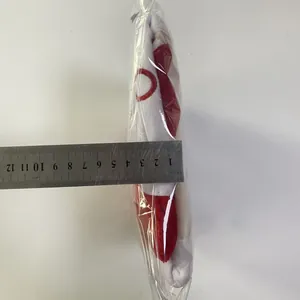 Detail showing the 3.8cm thickness of the plush Christmas gift bag with red embroidery