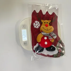 Detailed view of a Christmas stocking with a 3D reindeer doll being weighed on a scale