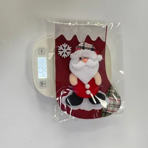 Detail view of a 3D Santa Burlap Christmas Stocking being weighed at 25.4g on a digital scale
