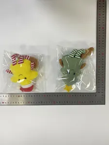Detail view of plush Christmas tree and star figurines with striped long legs and scale measurement