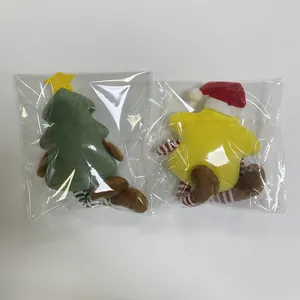 Detail of Christmas tree and star plush toys packaged in clear protective polybags