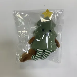Detail of Christmas tree plush toy with striped legs inside transparent packaging