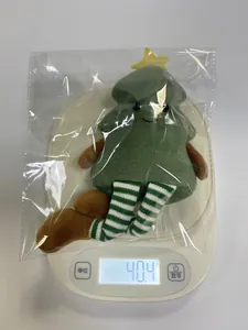 Macro view of plush Christmas tree doll weighing 40.4g on a white digital scale