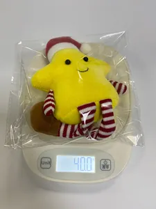 Weight measurement of a yellow plush Christmas star toy with a hat in packaging