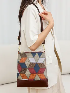 Quilted patchwork faux leather tote bag with colorful geometric patterns and shoulder strap