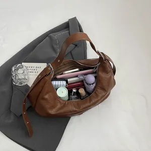 Large vintage brown faux leather tote bag showing spacious interior with daily essentials