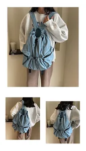 Detailed views of light blue nylon drawstring backpack with adjustable straps and zip pockets