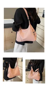 Detail of pink hobo bag featuring lychee grain leather and gunmetal side zipper pocket