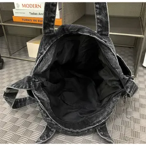 Top view of large capacity denim messenger bag interior with lining and slip pocket