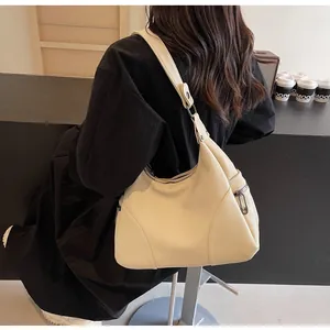 Detailed side view of beige leathery hobo bag showing large capacity and lychee texture