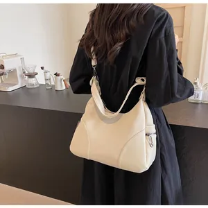 Close-up of creamy white lychee grain leather hobo bag with adjustable shoulder strap