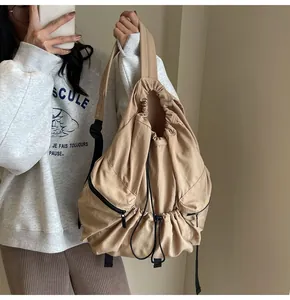 Detailed shot of khaki nylon drawstring backpack showing large capacity and sport style