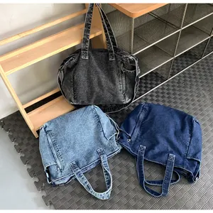 Three colors of durable denim messenger bags displayed on a wooden shelf in a cozy room