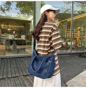 Outdoor shot of the large capacity dark blue denim messenger bag with external pockets