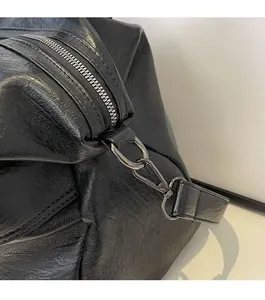 Detail of gunmetal zipper and high-gloss lychee texture leather on black shoulder bag