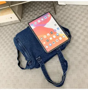 Detail showing deep blue denim messenger bag interior fitting a 10 inch tablet