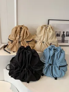 Minimalist nylon drawstring backpacks in four colors for daily commute and casual use