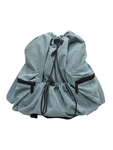 Light blue minimalist nylon drawstring backpack with side zipper pockets on white background