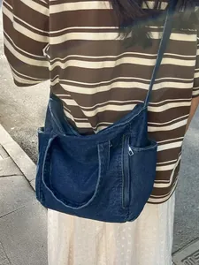 Large capacity dark blue washed denim messenger bag with metal zipper and wide straps
