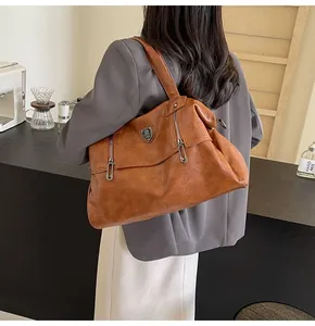 Brown vintage leather tote bag detail showing large capacity and shoulder strap design